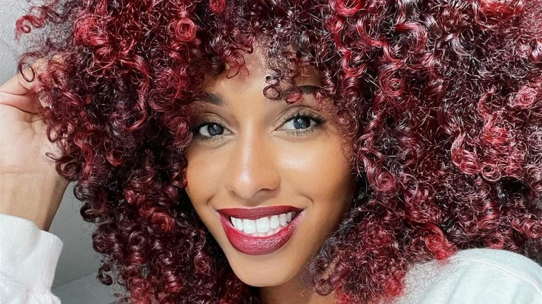 Woman with burgundy highlights