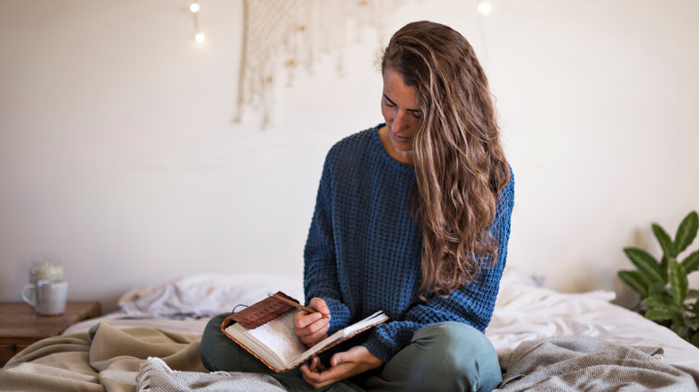 person writing in journal