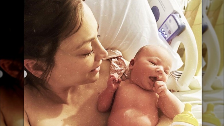 Candid shot of Kaley Cuoco in a hospital bed cuddling newborn daughter Matilda after delivery.