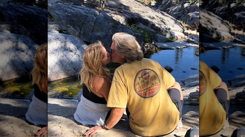 Goldie Hawn and Kurt Russell share a kiss while enjoying nature together