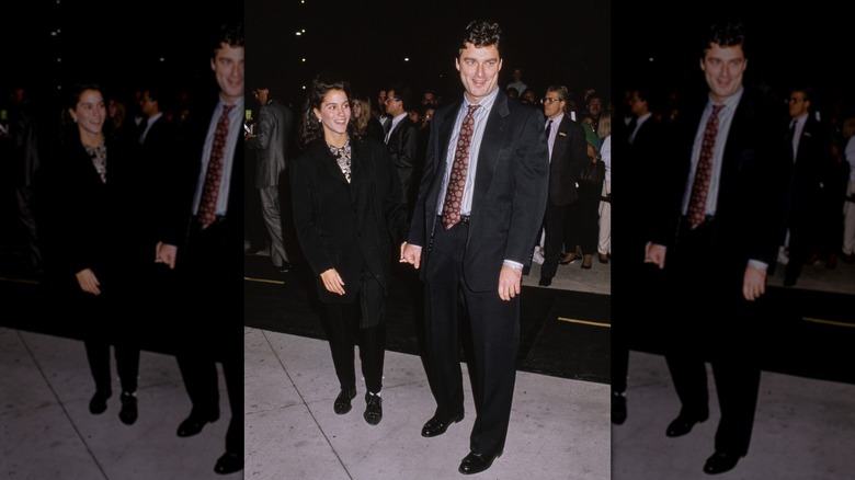 Jami Gertz and Tony Ressler holding hands at a premiere
