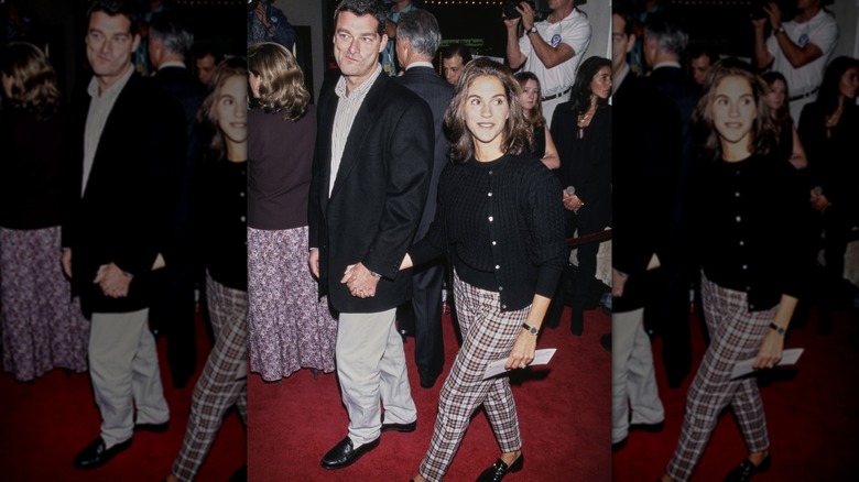 Jami Gertz and Tony Ressler holding hands at a premiere