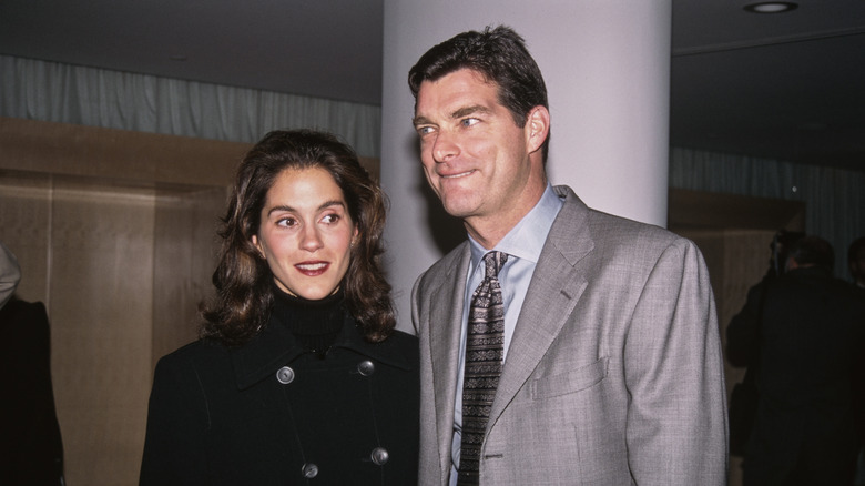 Jami Gertz and Tony Ressler standing close at a premiere in the '90s