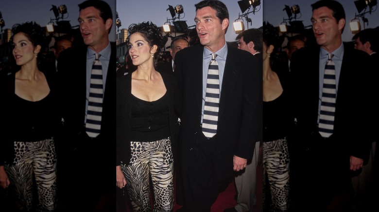 Jami Gertz and Tony Ressler holding hands at a premiere