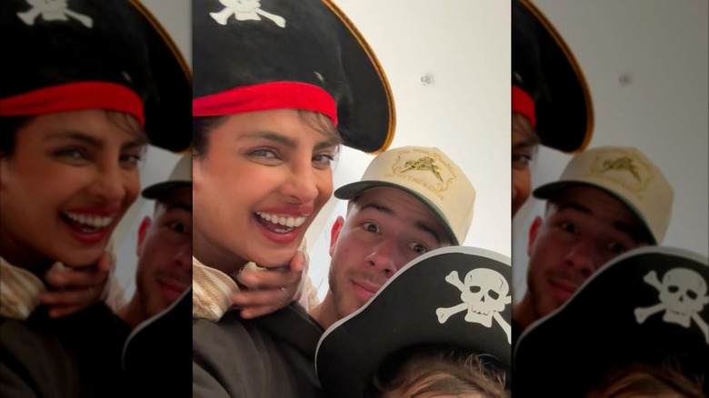 Priyanka Chopra, Nick Jonas, and their infant daughter take a selfie while wearing pirate hats