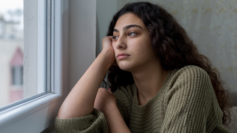 Woman looking out of window