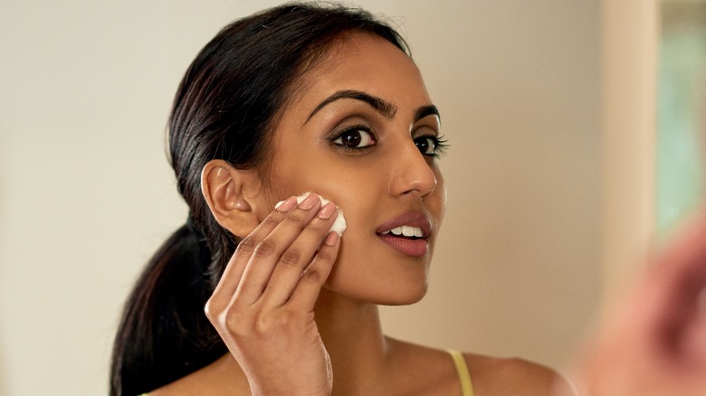person blotting their face
