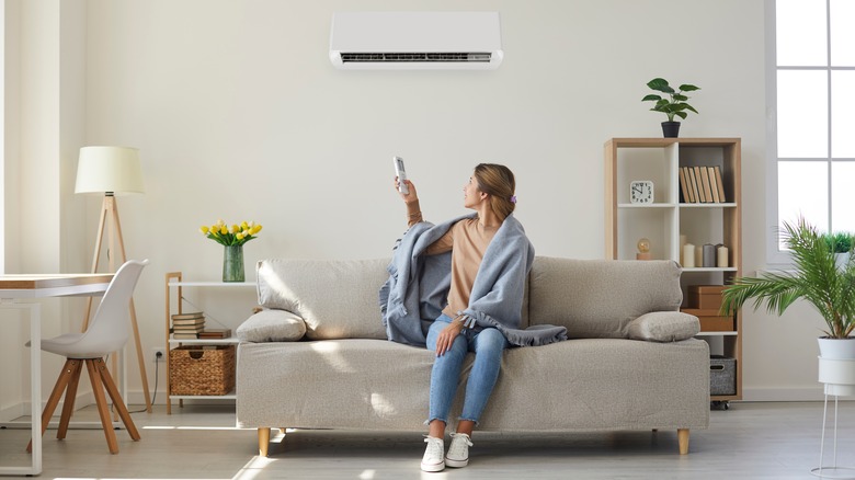 woman turning on ac unit