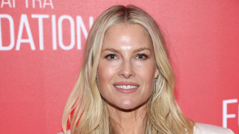 Ali Larter with wavy hair smiling at an event.