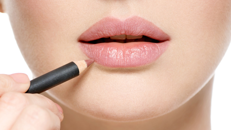 Woman applying lip liner