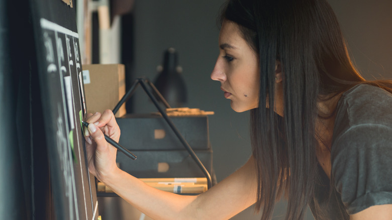 woman writing on calendar 