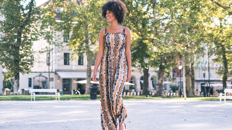 woman walking down street in maxi dress