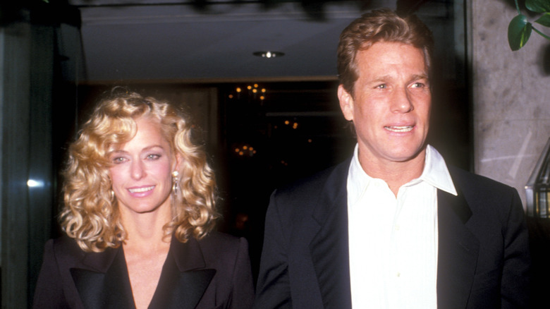 Farrah Fawcett and Ryan O'Neal are seen walking out of a building together
