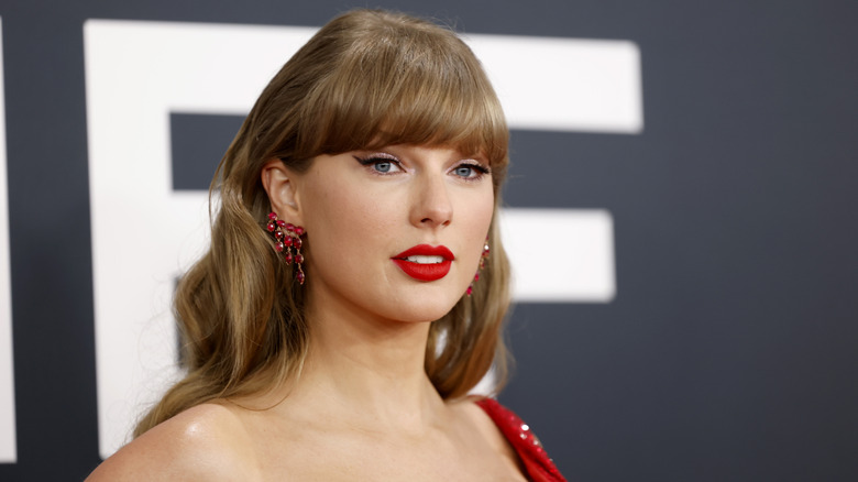 Taylor Swift in 2025 with red lipstick and winged liner