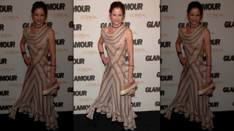 Ally Sheedy in 2005 wearing a flowy dress with an interesting pattern at a red carpet event.