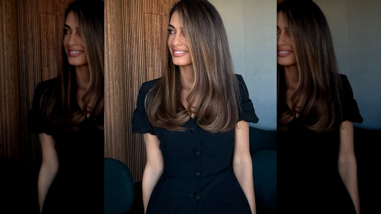 Amal Clooney with dark brown hair wearing a bubble blowout