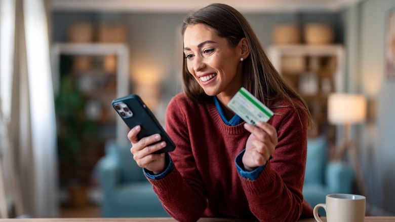 Smiling woman making online purchase