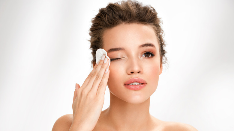 woman removing eye makeup