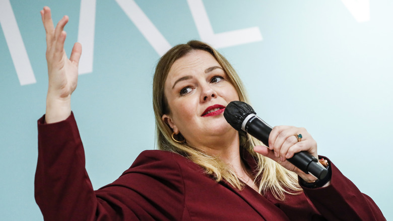 Amber Tamblyn giving a speech into a microphone