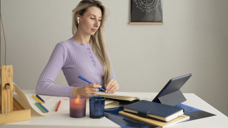 Woman writing in journal