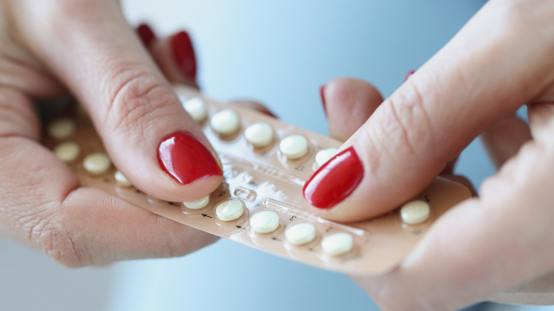 Person holding birth control pills