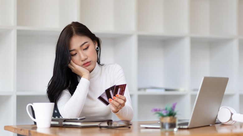 Woman looking at her credit cards