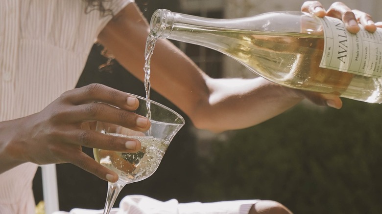 Woman pouring glass of wine