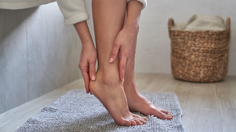 woman moisturizing feet