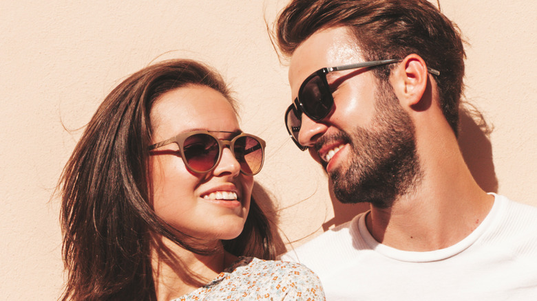 Couple smiling with sunglasses outside