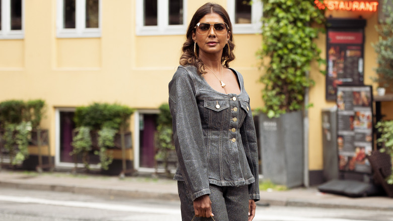 Woman in a dark-wash denim peplum set