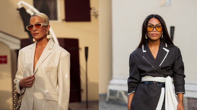 A woman wearing a white sequined blazer on the left and a woman wearing a black blazer on the right