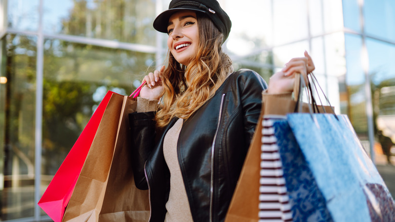 Woman shops wearing black jacket and hat