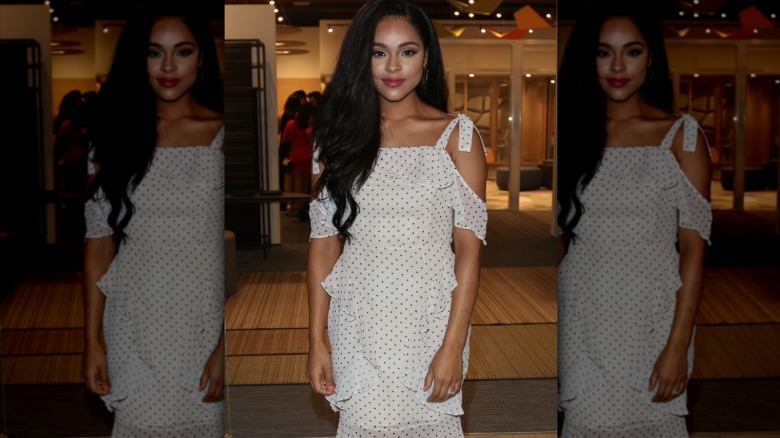 Actor Ash Santos wearing a polka-dot cold-shoulder dress