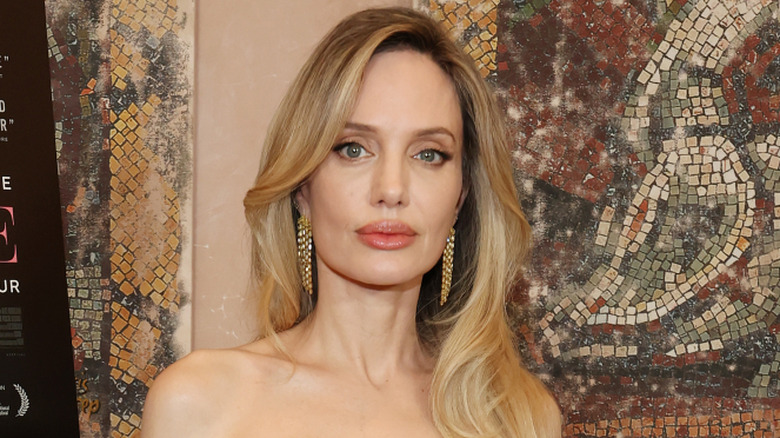 Angelina Jolie posing at a Couture event.
