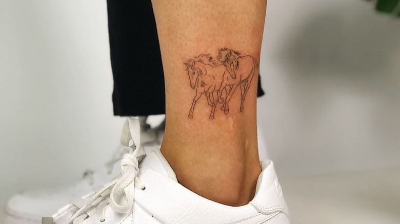 Fine-line horse tattoo on ankle