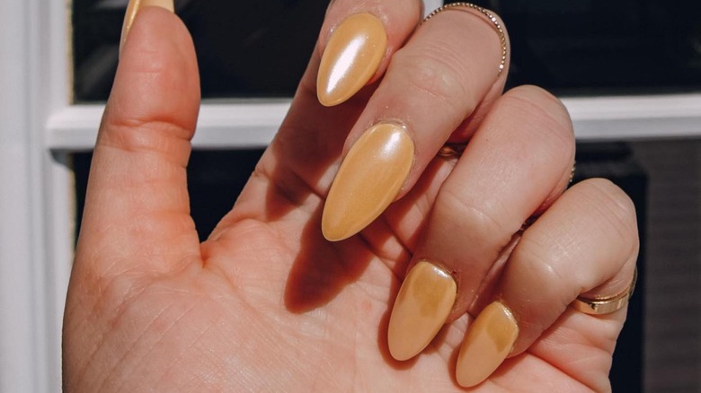 Apricot chrome nails on hand