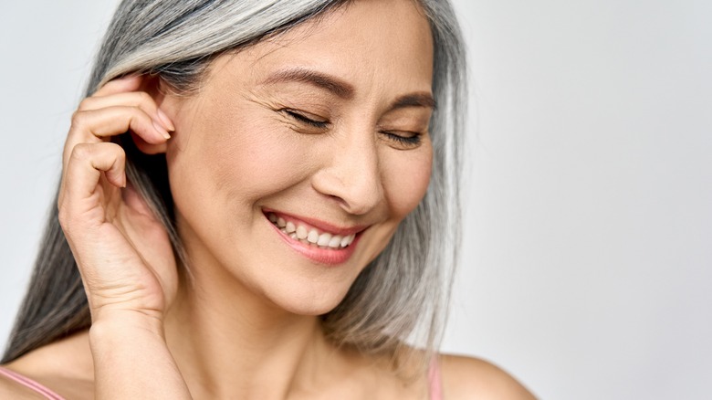 Woman with white hair smiles