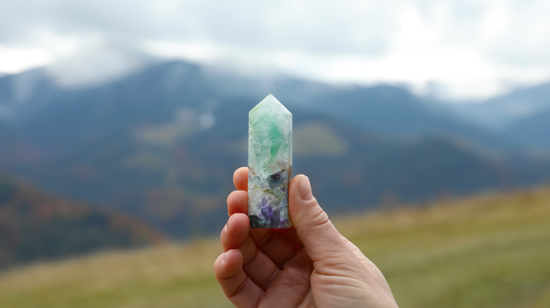 Woman holding fluorite crystal