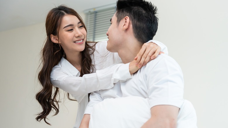 a couple smiling in bed