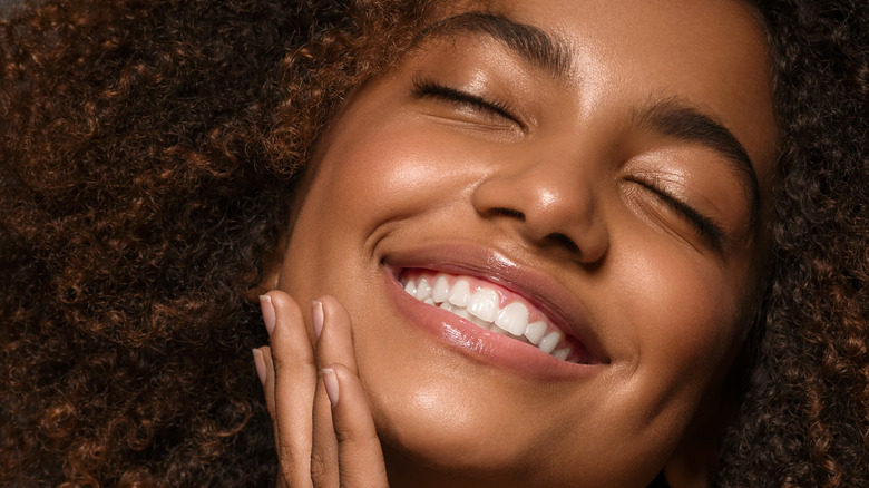 smiling young woman with moisturized skin