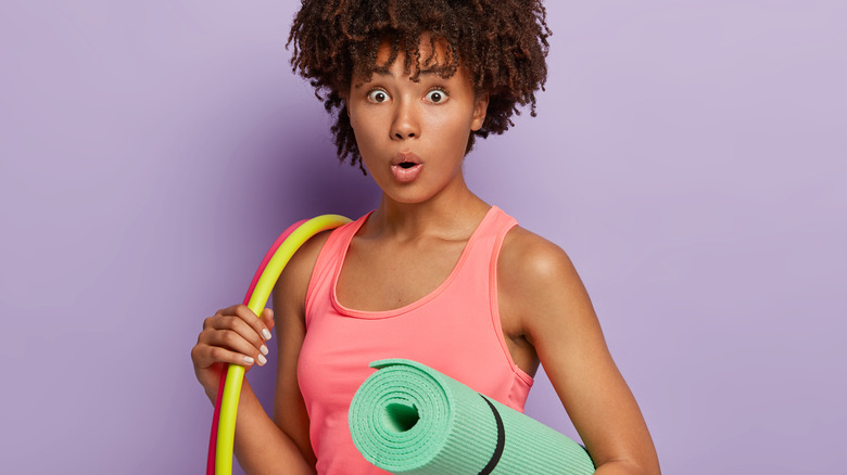 young woman hula hooping for fitness