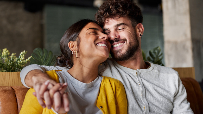 smiling couple holding hands