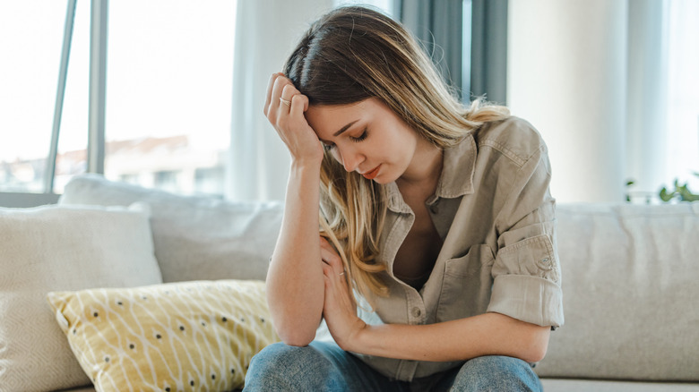 Overwhelmed woman on couch