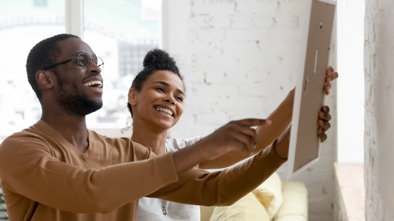 Couple holding artwork