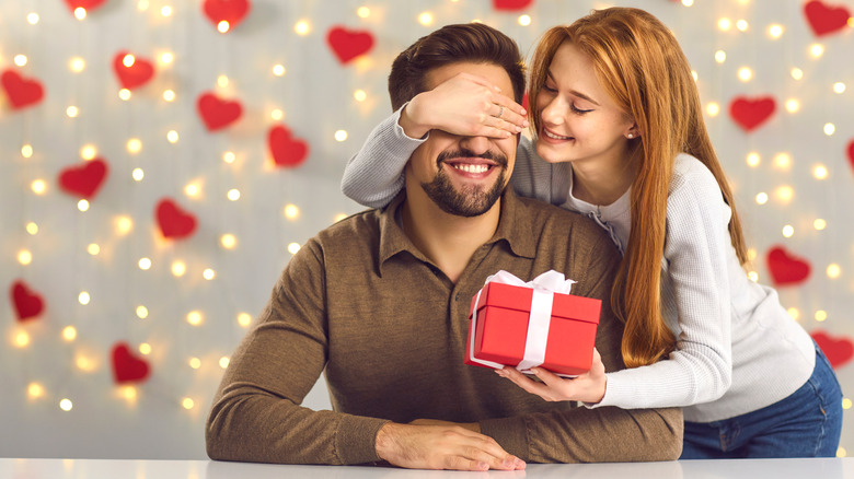 Woman giving gift to boyfriend