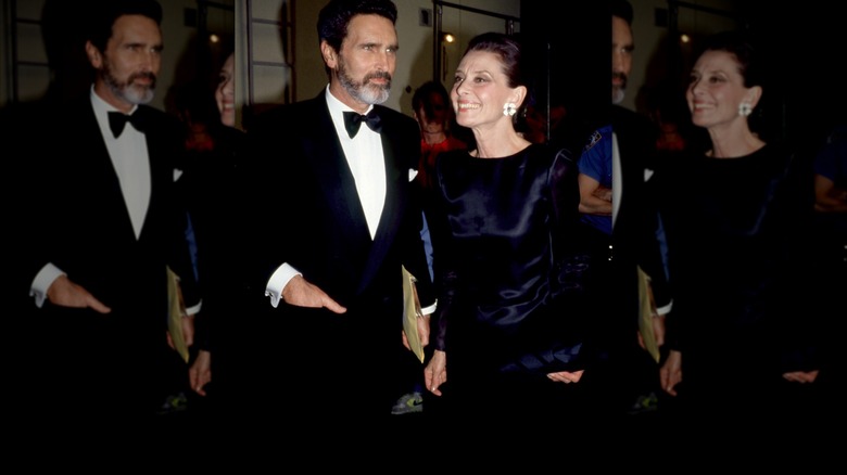 Audrey Hepburn at the Tony Awards wearing a dark-blue satin dress.