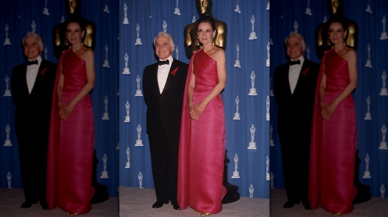Audrey Hepburn at the Oscars wearing a magenta one-shoulder gown.