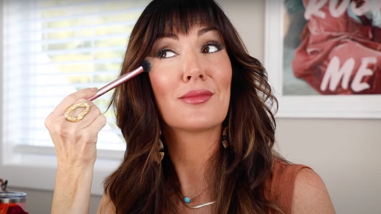 Woman applying pink powder