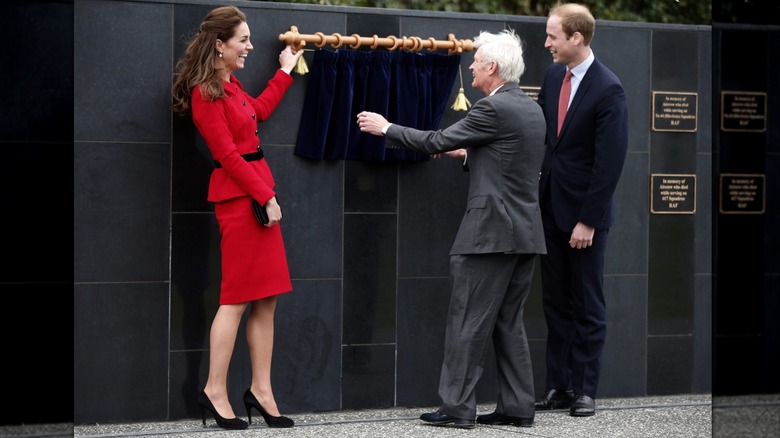 Catherine, Duchess of Cambridge and Prince William, Duke of Cambridge have a laugh as a curtain malfunctions at the Wigram Air Base Museum on April 14, 2014 in Christchurch, New Zealand (2014)