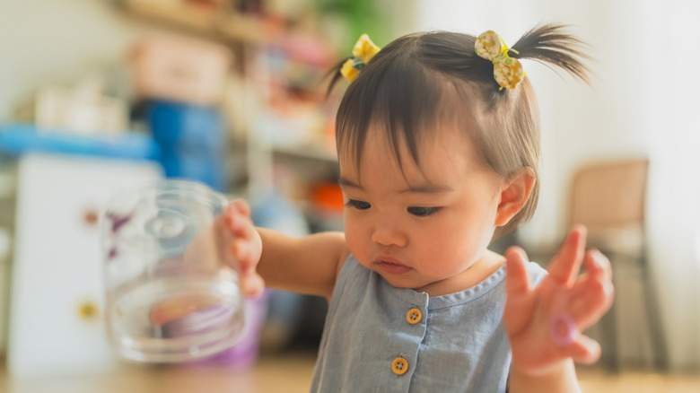 A baby with pigtails and bows